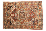 Antique Haji Jalili Tabriz rug with a concentric rust medallion and floral vinery on an ivory field.