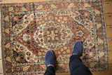 Top-down perspective of an antique Haji Jalili rug, highlighting the concentric medallion and time-softened low pile.