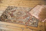 A traditional antique Persian Tabriz rug with a medallion design in rust, ivory, and sapphire.