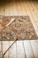 Antique Persian Haji Jalili rug showcasing its warm rust and ivory palette in a room setting.