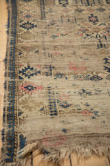 Worn edge of antique Caucasian rug, showing foundation, fringe loss, and geometric motifs.