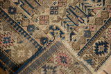 Geometric plant motifs, hard wear, and hand-knotted foundation of this antique Caucasian rug.