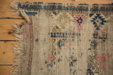 Worn edge of an antique Caucasian rug, revealing foundation and historic pattern remnants.