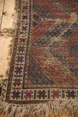 Antique Caucasian rug corner, geometric hook and latch border, madder red, navy, hard tatter.