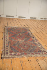 Antique Caucasian rug with a tattered fringe and worn geometric border.