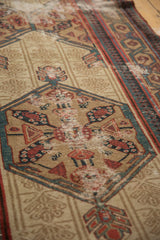 Antique Serab runner's geometric medallion, madder red, indigo blue, beige, with foundation visible.