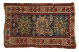 Antique Caucasian rug with triple starburst medallions, indigo blue field, and an oversized floral blossom border, 3x5.