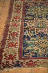 Antique Caucasian rug's unusual oversized floral blossom border in cherry red, beige, and indigo.