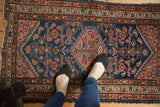 Vintage Borchalou rug, indigo blue field, blush diamond medallion and Herati motif.
