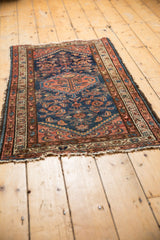 Vintage Borchalou rug corner: indigo Herati field, deep blush border, worn fringe.