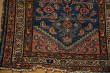Vintage Borchalou rug corner: indigo field with Herati pattern, blush stepped medallion, and worn fringe.