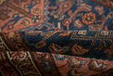 Detailed texture of vintage Borchalou rug pile, with indigo, blush, and golden knot heads.