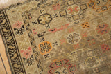 Close-up of antique Caucasian rug with even wear to knot heads, tribal geometric motifs.