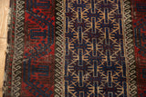 Low pile Vintage Belouch rug with navy geometric gul and wave motif border.