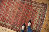 Antique Hamadan rug with unique asymmetric Mehrab end, ruby red boteh pattern.