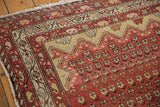 Unique asymmetric saffron yellow Mehrab overlay and repeating boteh on antique Hamadan rug.