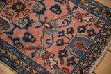 Plush pile of a Vintage Lilihan rug, showing blush field, blue tendrils, and floral vine borders.