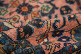 Plush, hand-knotted pile of a vintage Lilihan rug mat, highlighting blush, navy, and gold floral patterns.