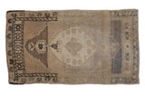 Distressed vintage Oushak rug mat, center medallion, stepped border, muted beige, brown, pale mauve abrash.