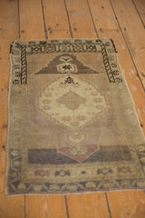 Stepped central medallion with abrash details on the distressed vintage Oushak rug.