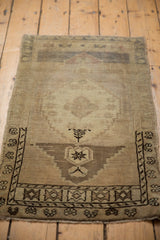 Detailed Turkish stepped border and end finial on a distressed Oushak rug mat.
