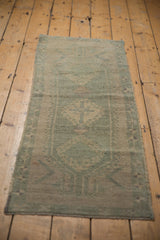 Distressed texture in seafoam green and ivory on the secured Oushak rug edge.