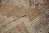 Distressed low pile texture, wear to knot heads, and woven foundation of vintage Oushak rug.