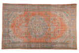 Distressed vintage Oushak carpet, tangerine orange, pale blue medallion, sprawling floral vinery with worn texture, 6x9.5.