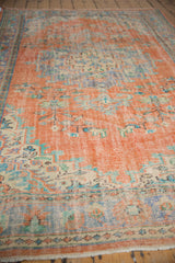 Distressed Oushak carpet with tangerine, royal blue, and ivory floral design 6' x 9'8