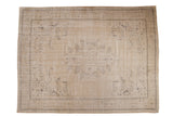 Vintage distressed Oushak carpet, sand and beige with faded brown medallion and botanical motifs.