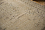 Distressed Oushak rug with faded sand and coffee brown motifs and even pile wear.