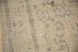 Decorative vintage distressed Oushak texture showing sand, beige, and faded brown floral patterns.