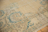Close-up of distressed vintage Oushak rug, showing European scrolling vines, soft contours, and worn texture.