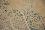 Distressed vintage Oushak pile with visible hand-knotted foundation showing through.