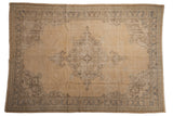 Distressed vintage Oushak carpet with sand, beige, silver, and coffee brown medallion and patterns.