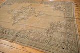 Faded sand and silver corner spandrel of a distressed vintage Oushak rug with even wear.
