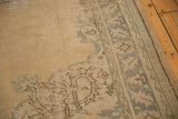 Oushak carpet with distressed sand field, silver border, and foundation showing through.