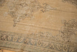 Distressed vintage Oushak rug displaying sand tones, faded patterns, and visible low pile texture.