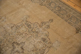 Distressed vintage Oushak carpet detail with sand, silver tones, and even wear to knot heads.