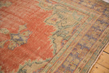 Even wear across the distressed Oushak pile, showing pale brick red and muted patterns.