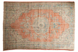 Distressed vintage Oushak carpet with faded cherry red medallion, sky blue, and ivory floral patterns, 5'11