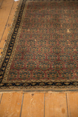Antique Afshar rug end, aubergine boteh pattern, navy border, visible wear.