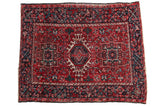 Hand-knotted vintage Karaja rug, cherry red field, central hook and latch medallion.