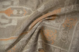 Textured low pile and pale tangerine orange motifs on a distressed vintage Oushak rug.