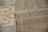 Distressed Oushak rug pile with ivory, silver, tangerine tones, revealing hand-knotted reverse.