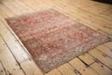 Corner view of Farahan Sarouk rug, highlighting scrolling vinery, abrash, and fringed edge.