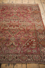 Vintage Farahan Sarouk rug end: detailed floral border, secured fringe, wine red, charcoal.