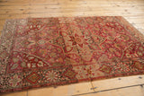 Farahan Sarouk rug detail, wine red abrash field, scrolling vinery, and floral starburst medallion.