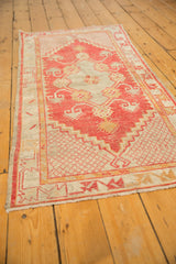 Distressed Oushak runner, red and beige floral border with faint foundation showing.