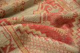 Distressed texture of vintage Oushak rug with bright red, beige, and gold patterns.